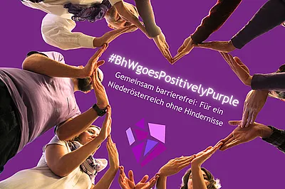 Teammitglieder des BhW formen mit ihren Händen ein großes Herz. In der Mitte steht: „#BhWgoesPositivelyPurple. Gemeinsam barrierefrei: Für ein Niederösterreich ohne Hindernisse“